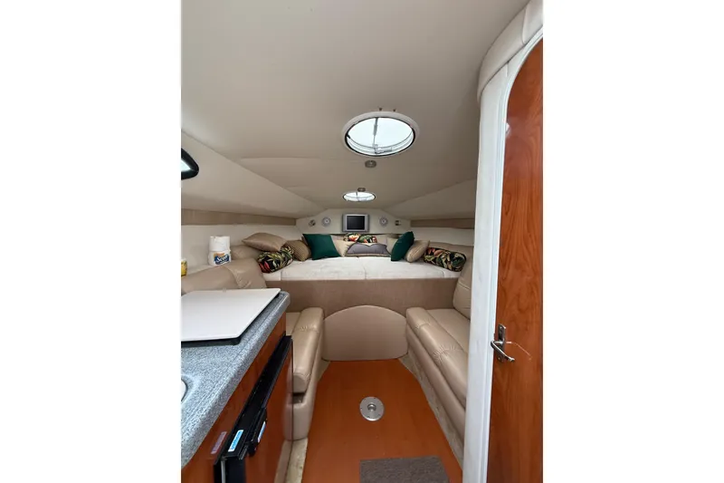 Slide: The Image of 2005 Larson Cabrio 290 cabin interior with cozy seating and modern amenities. - 34