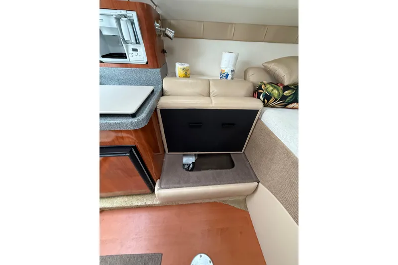 Slide: The Image of Interior of 2005 Larson Cabrio 290 boat with kitchenette and seating area. - 37
