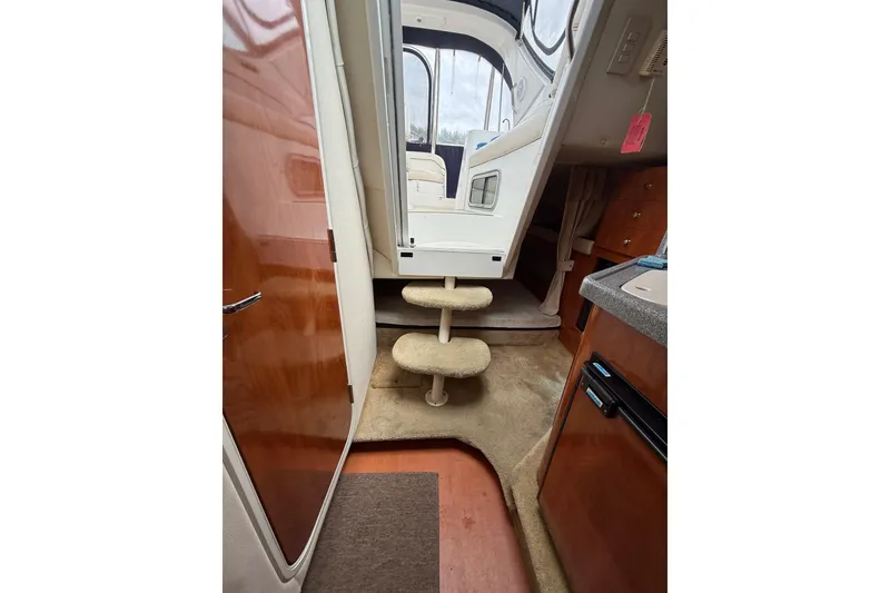 Slide: The Image of Interior view of 2005 Larson Cabrio 290 boat, featuring steps and cabin amenities. - 40