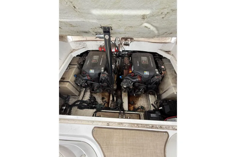 Slide: The Image of Engine compartment of 2005 Larson Cabrio 290 boat, featuring dual inboard motors. - 42