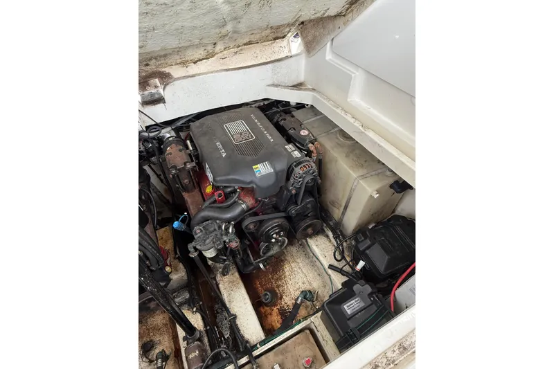 Slide: The Image of Engine compartment of a 2005 Larson Cabrio 290 boat, showing detailed mechanical components. - 44