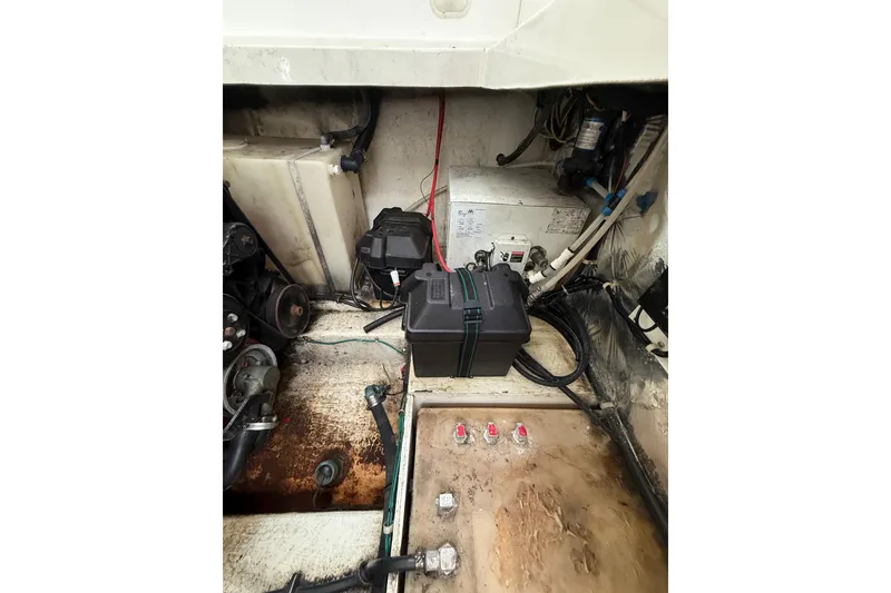 Slide: The Image of Engine compartment of a 2005 Larson Cabrio 290 boat, showing battery and wiring. - 49