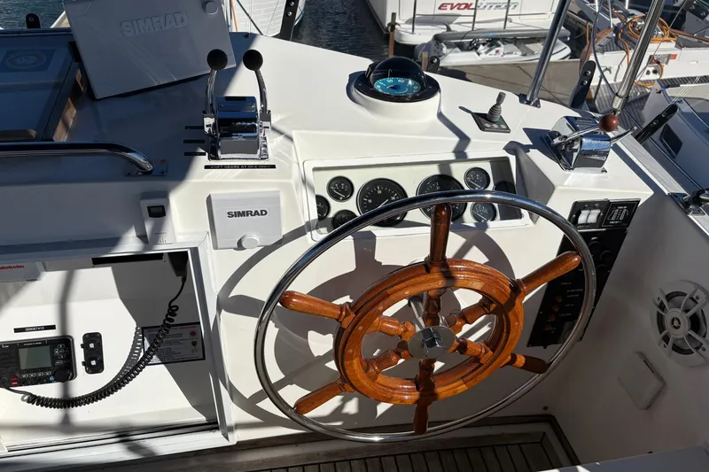 Slide: The Image of 1995 Grand Banks 42 Motoryacht helm with wooden steering wheel and navigation instruments. - 10