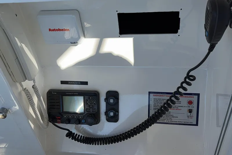 Slide: The Image of Control panel of a 1995 Grand Banks 42 Motoryacht with radio and emergency procedures. - 11