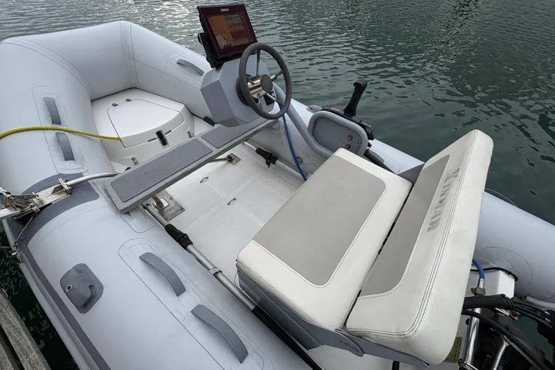 Slide: The Image of Inflatable boat with steering console, docked on water, associated with 1995 Grand Banks 42 Motoryacht. - 20