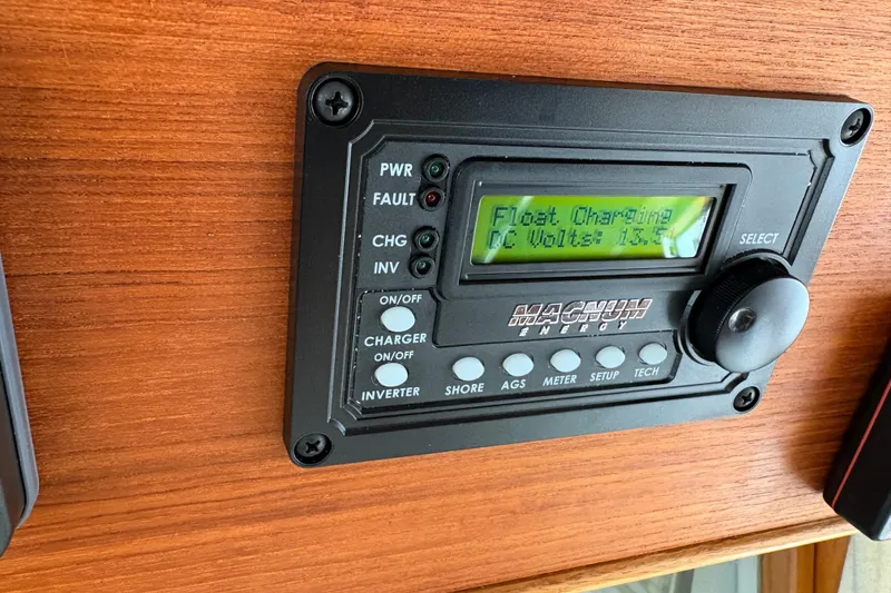 Slide: The Image of Control panel on 1995 Grand Banks 42 Motoryacht displaying charging status and DC voltage. - 25