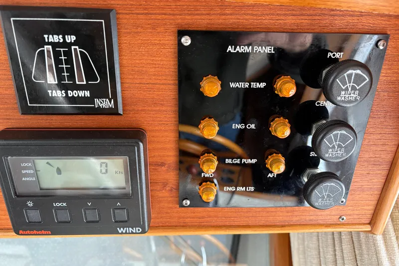 Slide: The Image of Control panel of a 1995 Grand Banks 42 Motoryacht with alarm indicators and wiper controls. - 28