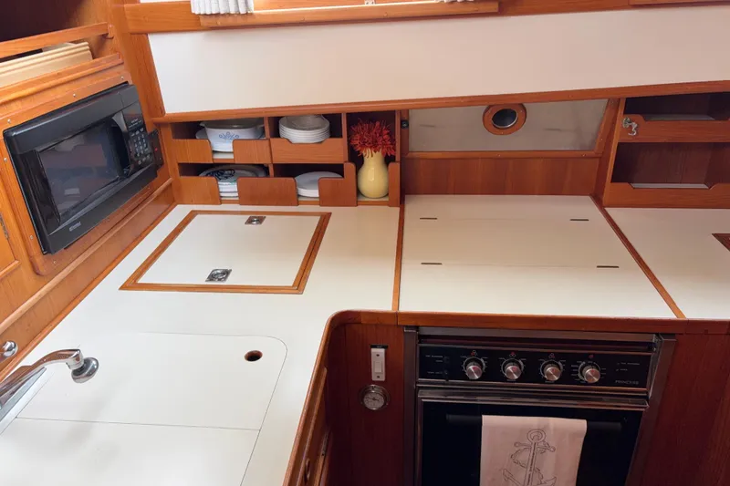 Slide: The Image of Electric stove, oven, microwave, toaster oven, deep freezer, double refrigerator and storage. - 32