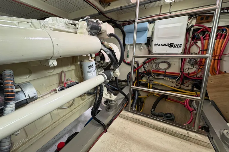 Slide: The Image of Engine room of 1995 Grand Banks 42 Motoryacht with visible wiring and machinery. - 43