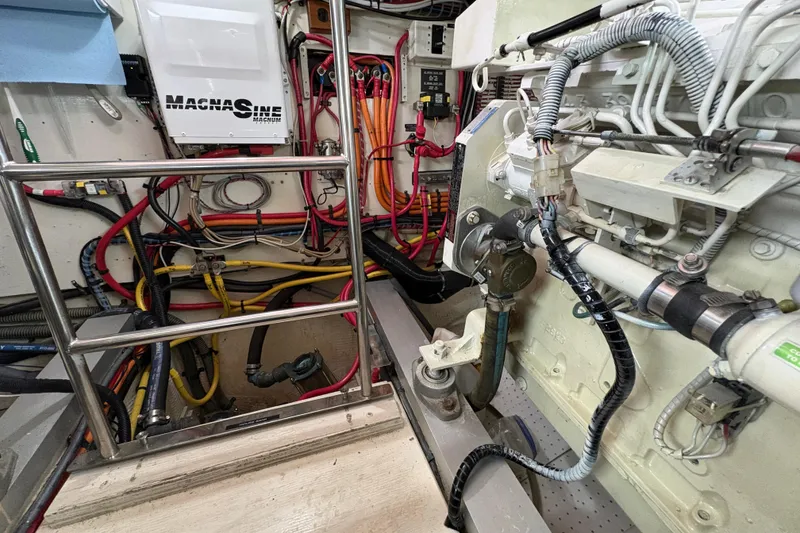 Slide: The Image of Engine room of a 1995 Grand Banks 42 Motoryacht with wiring and mechanical components. - 44