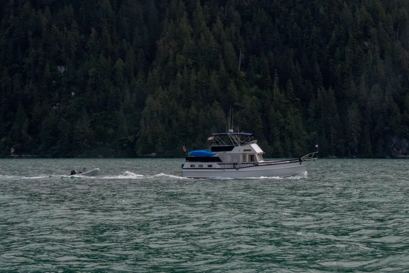 Slide: The Image of Grand Banks 42 Motoryacht cruising on a scenic lake with forested hills, 1995 model. - 5