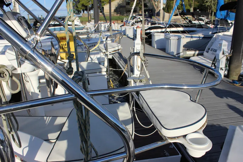 Slide: The Image of 2014 Hunter 33 sailboat docked, featuring polished metal railings and deck equipment. - 15