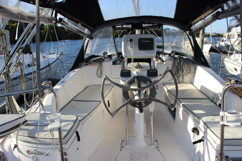 Slide: The Image of Cockpit of 2014 Hunter 33 sailboat with steering wheel and navigation equipment. - 18
