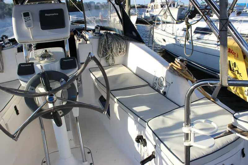Slide: The Image of Cockpit of 2014 Hunter 33 sailboat with steering wheel and navigation equipment. - 19