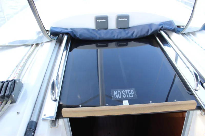 Slide: The Image of 2014 Hunter 33 sailboat cockpit with "No Step" warning on glossy hatch. - 31