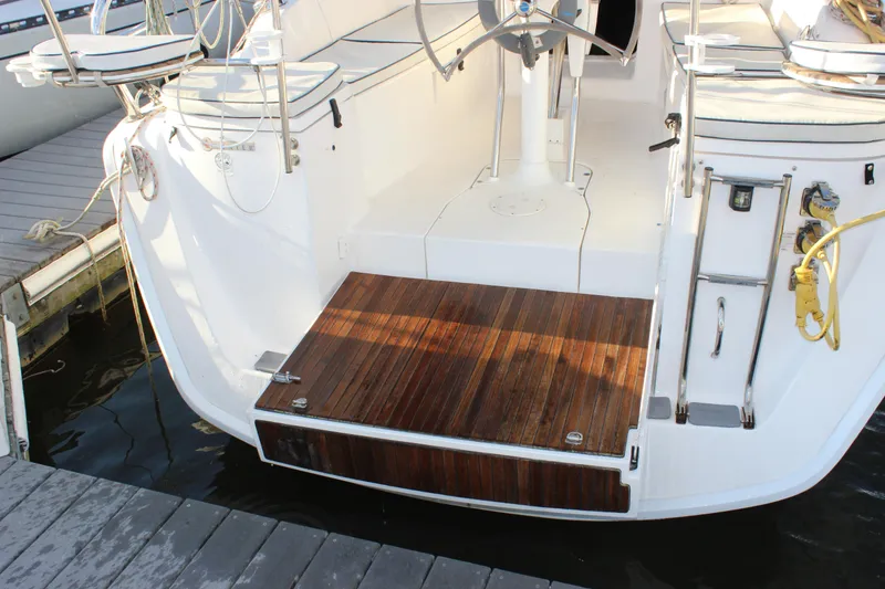 Slide: The Image of Hunter 33 sailboat stern with teak swim platform and ladder, docked at marina, 2014 model. - 4