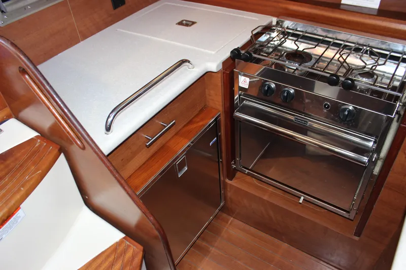 Slide: The Image of Compact kitchen area in a 2014 Hunter 33 sailboat with stove and storage. - 41