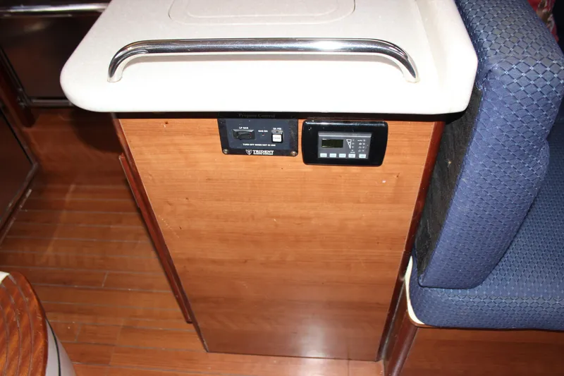 Slide: The Image of 2014 Hunter 33 yacht interior with control panel and seating area. - 42