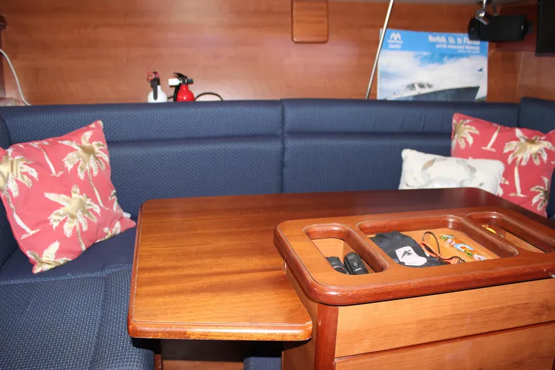 Slide: The Image of Interior of 2014 Hunter 33 sailboat with wooden table and blue seating. - 46