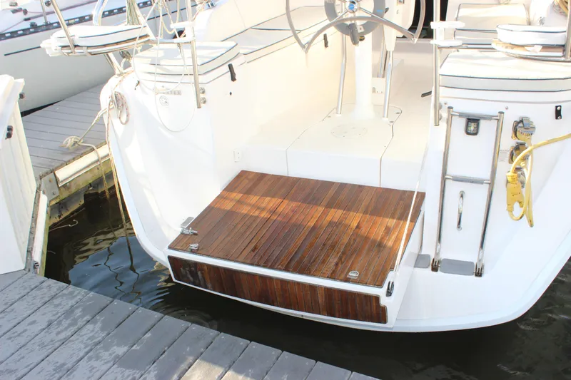 Slide: The Image of Hunter 33 sailboat (2014) with teak swim platform and dual steering wheels at dock. - 5