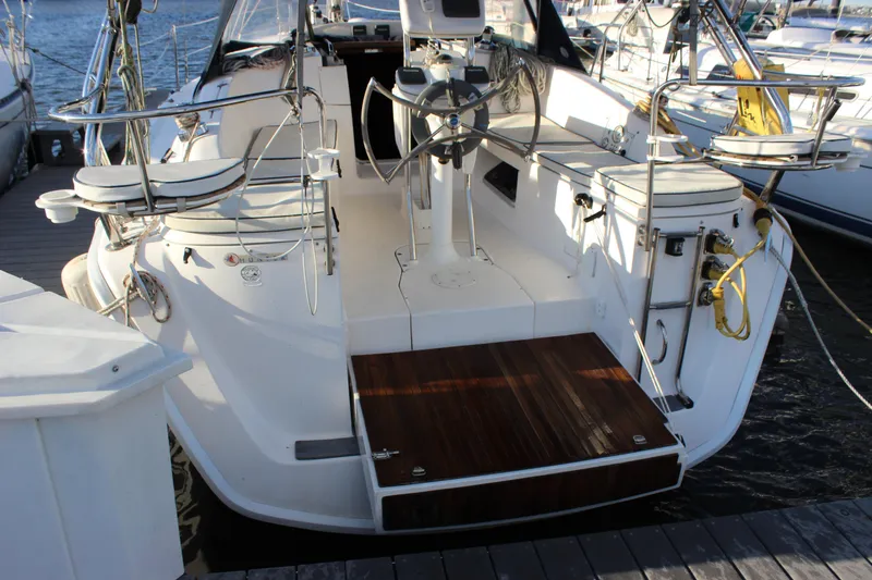 Slide: The Image of 2014 Hunter 33 sailboat cockpit with steering wheel and docked at marina. - 6
