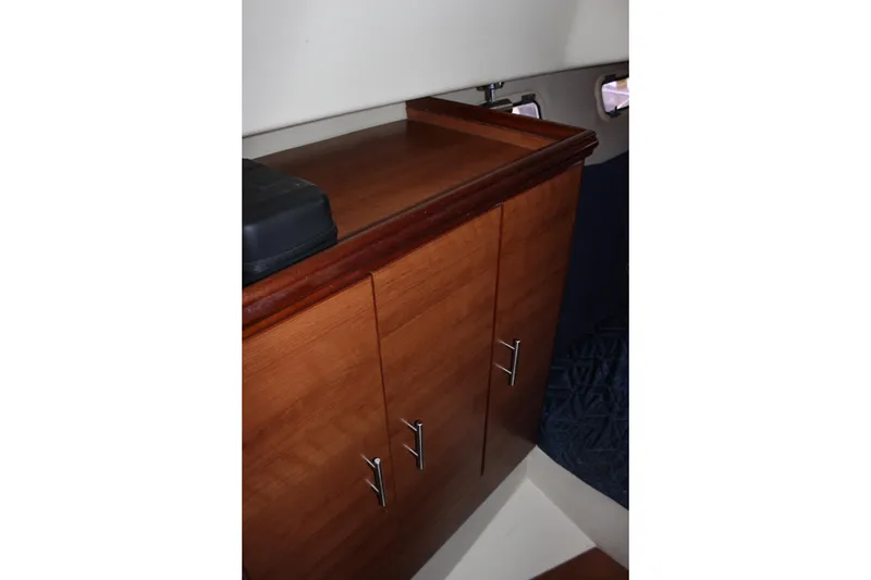 Slide: The Image of Wooden cabinet inside 2014 Hunter 33 boat cabin with sleek handles. - 60