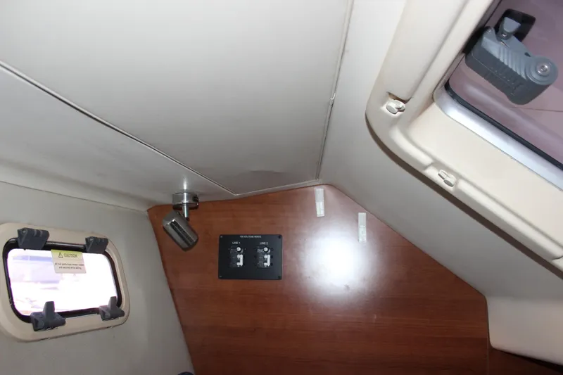 Slide: The Image of Interior of 2014 Hunter 33 sailboat with control panel and window. - 61