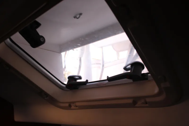 Slide: The Image of Cabin hatch view inside 2014 Hunter 33 sailboat, showcasing window latches. - 62