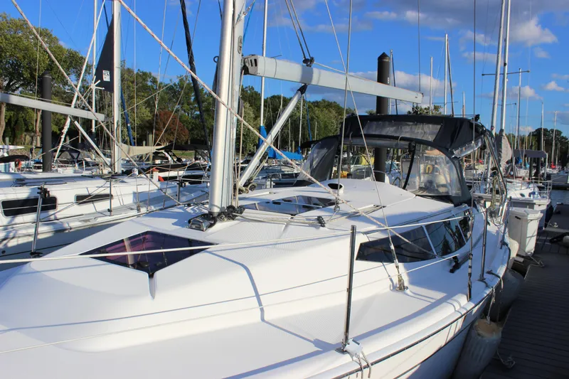 Slide: The Image of 2014 Hunter 33 sailboat docked at marina under clear blue sky. - 8