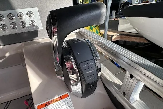 Slide: The Image of Throttle control of 2021 Harris Solstice 230 boat, featuring sleek design and intuitive buttons. - 16