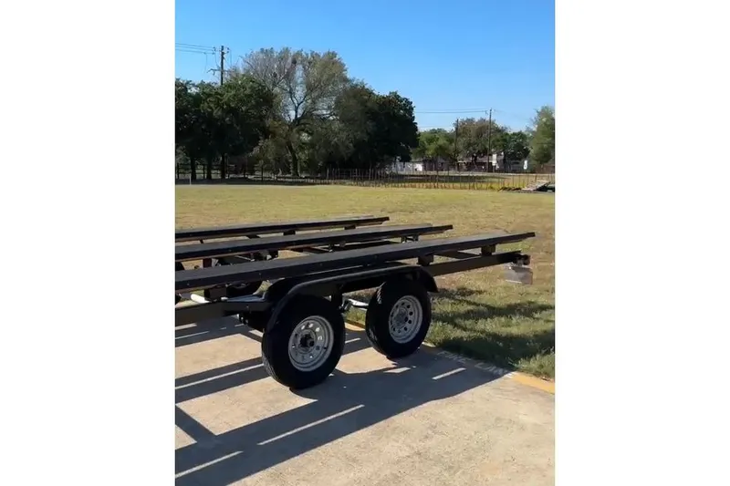 Slide: The Image of Trailer for 2021 Harris Solstice 230 pontoon boat on grassy area. - 22