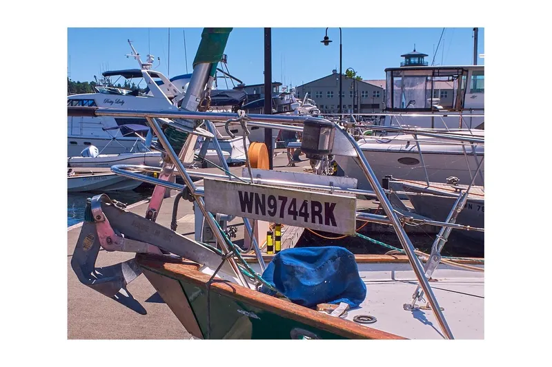 Slide: The Image of 1981 Valiant Cutter sailboat docked, displaying registration WN9744RK. - 11