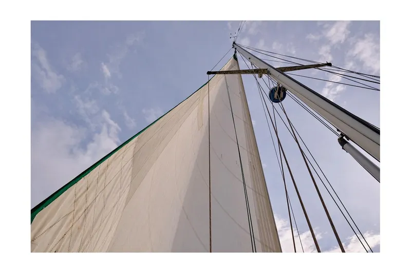 Slide: The Image of Sailboat mast and sail of 1981 Valiant Cutter against a cloudy sky. - 14