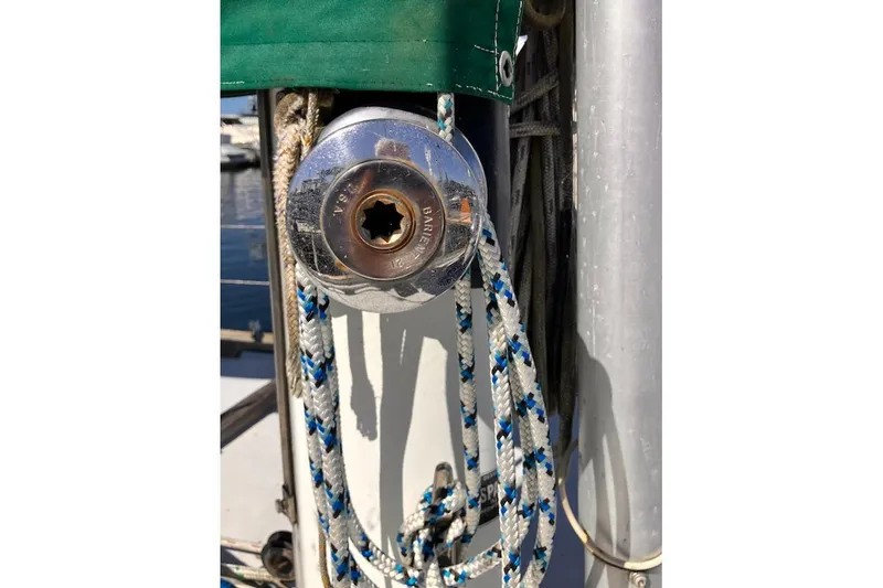 Slide: The Image of Close-up of a 1981 Valiant Cutter sailboat winch with ropes and green canvas. - 17