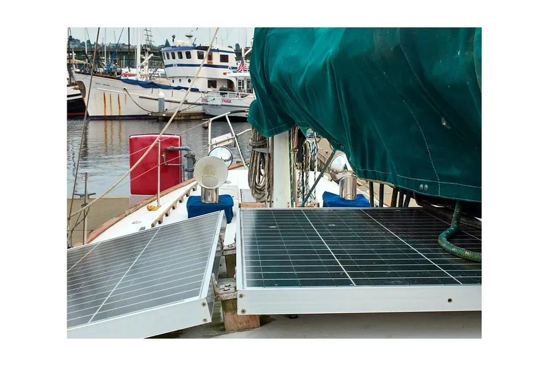 Slide: The Image of 1981 Valiant Cutter sailboat with solar panels docked at marina. - 23
