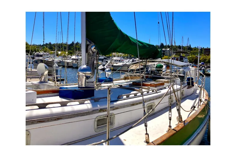 Slide: The Image of 1981 Valiant Cutter sailboat docked in a marina under clear blue skies. - 25
