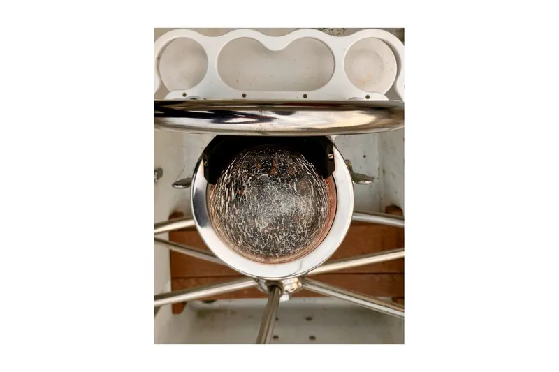 Slide: The Image of 1981 Valiant Cutter boat helm with a weathered compass and stainless steel details. - 33