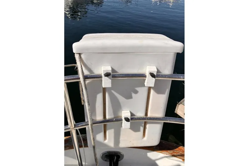 Slide: The Image of 1981 Valiant Cutter boat with white storage box on deck railing. - 37