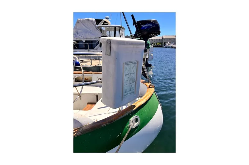 Slide: The Image of 1981 Valiant Cutter boat docked with visible Tohatsu motor and safety equipment. - 39