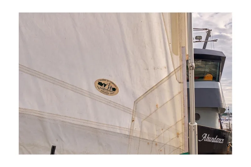 Slide: The Image of Sailboat with Valiant Cutter 1981, featuring a large sail and docked vessel. - 43