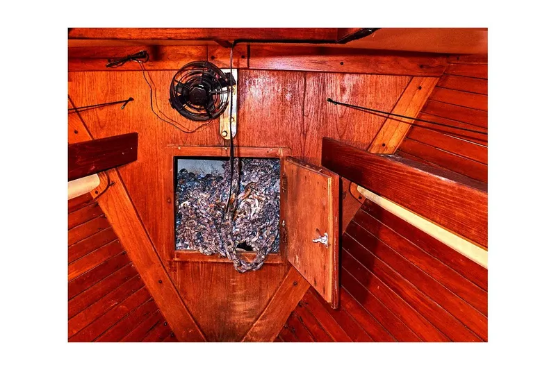 Slide: The Image of 1981 Valiant Cutter interior with wooden paneling and anchor chain storage. - 47