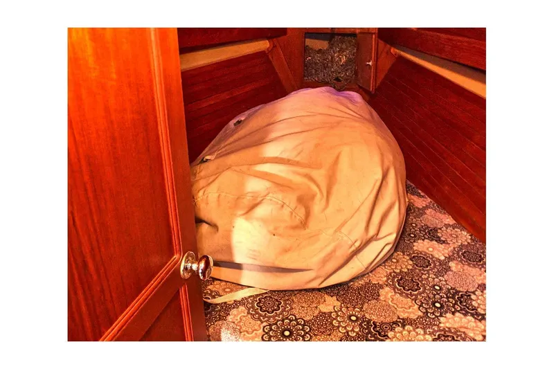 Slide: The Image of Interior of 1981 Valiant Cutter sailboat with patterned carpet and storage area. - 48