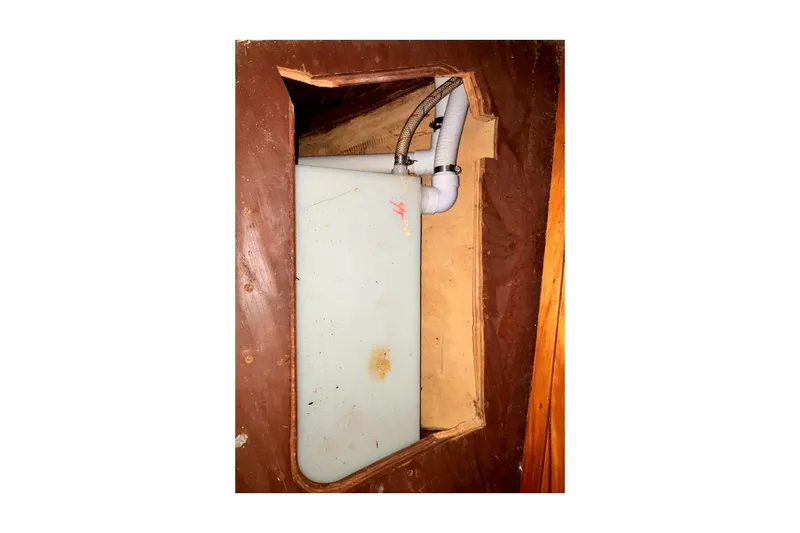 Slide: The Image of 1981 Valiant Cutter interior showing plumbing and storage compartment. - 50