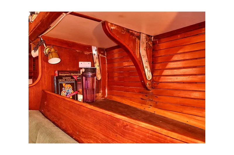 Slide: The Image of Interior of 1981 Valiant Cutter with wooden shelves, books, and a lamp. - 55