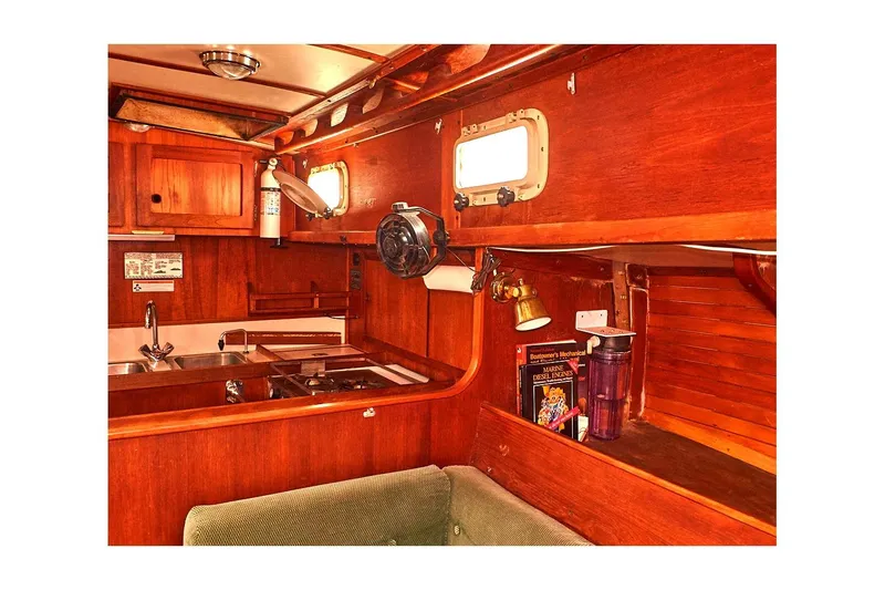 Slide: The Image of 1981 Valiant Cutter yacht interior with wooden cabinetry and nautical decor. - 57