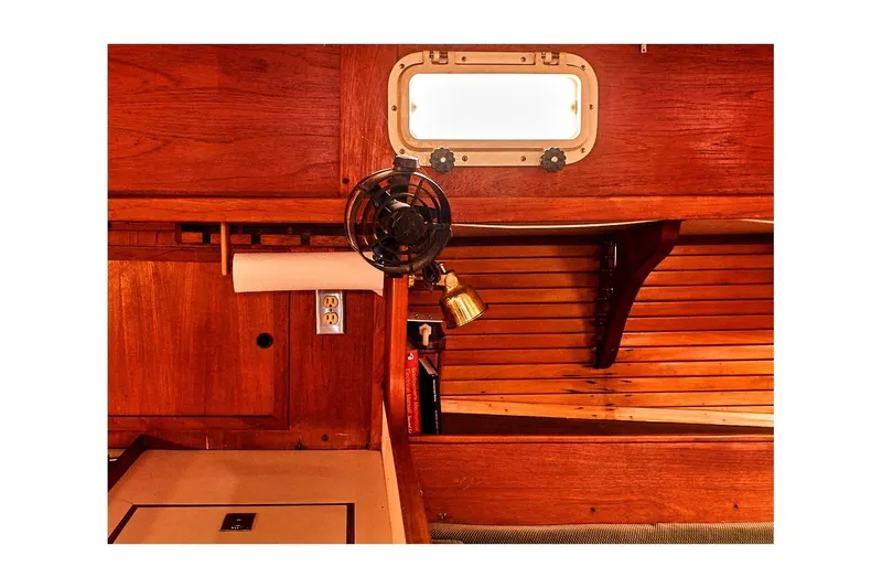 Slide: The Image of Interior of 1981 Valiant Cutter sailboat with wooden paneling and vintage fan. - 58