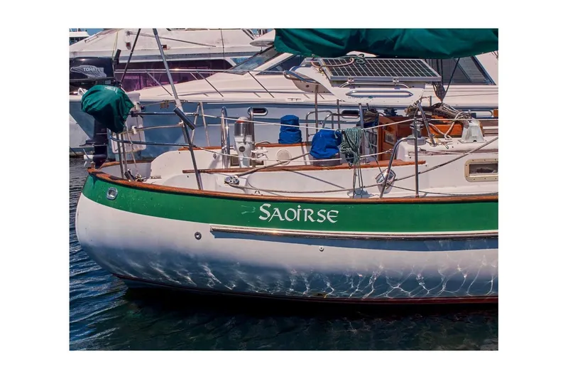 Slide: The Image of 1981 Valiant Cutter sailboat "Saoirse" docked, featuring green and white hull design. - 6