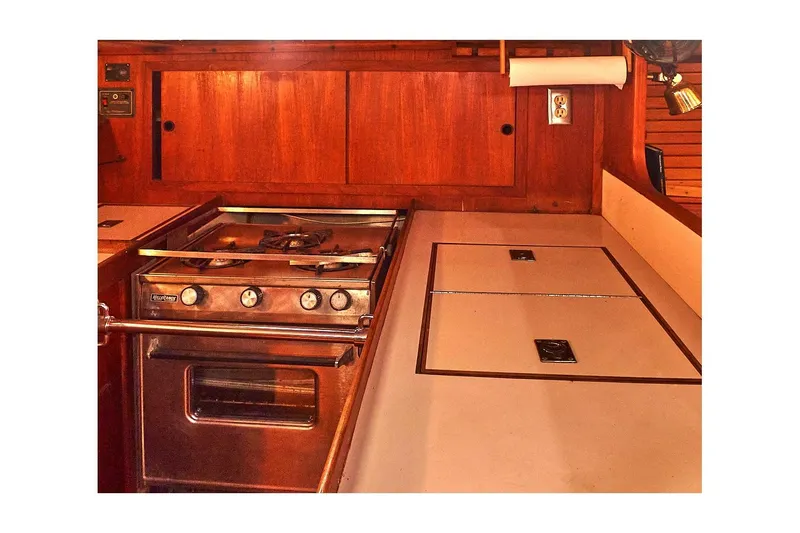 Slide: The Image of 1981 Valiant Cutter yacht kitchen with stove and wooden cabinetry. - 62