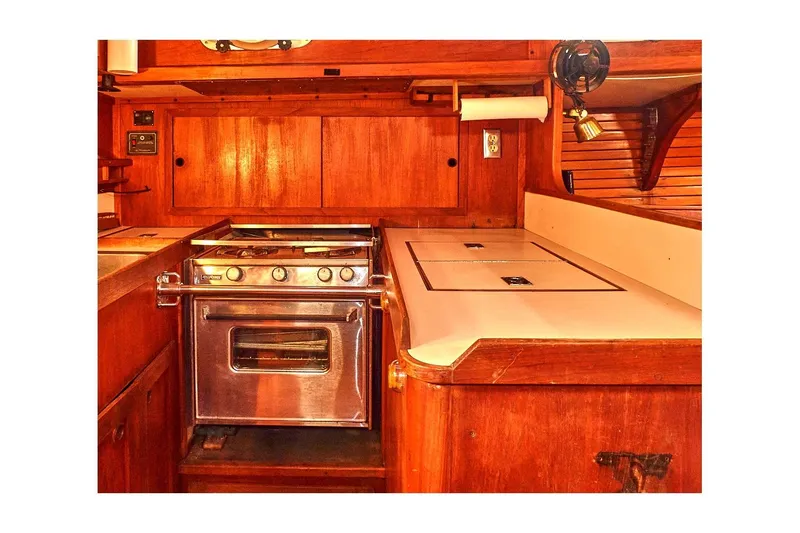 Slide: The Image of 1981 Valiant Cutter yacht interior with wooden cabinetry and stainless steel stove. - 63