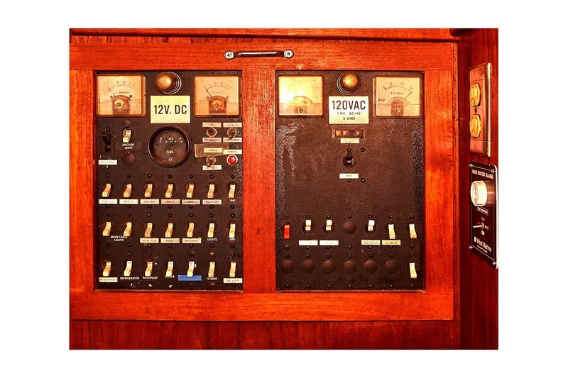 Slide: The Image of 1981 Valiant Cutter electrical panel with 12V DC and 120VAC switches and gauges. - 73
